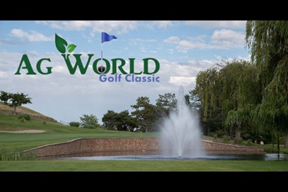 Golf course water feature on a sunny day with white clouds in the sky.